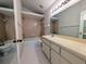 Full bathroom with a shower-tub combo, vanity, and white tile floor at 8209 Volusia Pl, Tampa, FL 33637