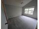 Neutral bedroom with a ceiling fan, window, and plush carpeting at 8209 Volusia Pl, Tampa, FL 33637