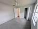 Open bedroom with carpet, a ceiling fan, and a closet at 8209 Volusia Pl, Tampa, FL 33637