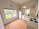 Bright kitchen featuring wood-look floors and modern appliances and backyard view at 8209 Volusia Pl, Tampa, FL 33637