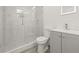 Modern bathroom with a glass shower, penny tile floor, and vanity with light-up mirror at 8215 N 14Th St, Tampa, FL 33604