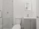 Modern bathroom featuring a glass-enclosed shower with marble tile and illuminated mirror at 8215 N 14Th St, Tampa, FL 33604