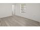 Bedroom with new floors, fresh paint, trim and natural light through a large window at 8215 N 14Th St, Tampa, FL 33604