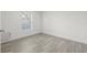 Bright bedroom with neutral walls, wood-look floors, and a window offering natural light at 8215 N 14Th St, Tampa, FL 33604