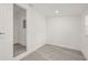 Bedroom with wood-look floors, closet, and natural light from a window, door ajar at 8215 N 14Th St, Tampa, FL 33604