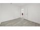 Bedroom with wood-look flooring and an open doorway to another room, and a closet at 8215 N 14Th St, Tampa, FL 33604
