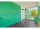 View of a covered front porch with stylish tile flooring and a welcoming entrance at 8215 N 14Th St, Tampa, FL 33604