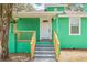 Front porch with updated railings and steps, leading to a bright front door at 8215 N 14Th St, Tampa, FL 33604