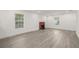 Bright living room featuring wood floors, a brick fireplace, and natural light from two large windows at 8215 N 14Th St, Tampa, FL 33604