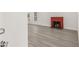Open living room with a charming red brick fireplace and new hard wood flooring at 8215 N 14Th St, Tampa, FL 33604