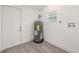 Utility room with wood-look floors, water heater, and hookups for washer and dryer at 8215 N 14Th St, Tampa, FL 33604
