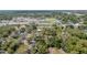 Expansive aerial view of a lively neighborhood, showcasing a sports stadium, lush trees, and tidy homes at 8525 N Ola Ave, Tampa, FL 33604