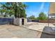 Spacious backyard with concrete patio, storage shed and partial fencing around the yard at 8525 N Ola Ave, Tampa, FL 33604