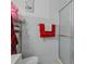 Bathroom features a glass enclosed shower, modern tiling, and updated fixtures at 8525 N Ola Ave, Tampa, FL 33604