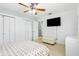 Inviting bedroom with ceiling fan, spacious closets, television and ample natural light at 8525 N Ola Ave, Tampa, FL 33604