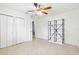 Cozy bedroom with ceiling fan, closet and a shelf at 8525 N Ola Ave, Tampa, FL 33604