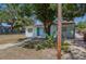 Cozy home featuring a cute garden bed, nice walkway, and a well-maintained lawn at 8525 N Ola Ave, Tampa, FL 33604