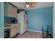 Bright kitchen features tile floor, ceiling fan, and appliances at 8525 N Ola Ave, Tampa, FL 33604