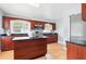 Charming kitchen features dark cabinets, stainless steel microwave, tile flooring, and a center island at 8525 N Ola Ave, Tampa, FL 33604