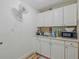 This kitchenette features white cabinets and a clean, efficient design at 8525 N Ola Ave, Tampa, FL 33604