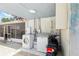 Back patio and laundry area features tile floor, washer/dryer, and access to screened in porch at 8525 N Ola Ave, Tampa, FL 33604