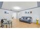 Open living room with tile flooring, neutral paint, couch, and plenty of natural light at 8525 N Ola Ave, Tampa, FL 33604