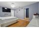 Bright bedroom with hardwood floors, fan, television and a walk-in closet at 8525 N Ola Ave, Tampa, FL 33604