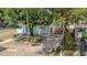 A cozy light blue house features a well-maintained lawn and backyard at 8525 N Ola Ave, Tampa, FL 33604