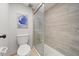 Contemporary bathroom featuring tile walls, a glass enclosed shower, and a toilet at 1028 Apollo Beach Blvd # 203, Apollo Beach, FL 33572
