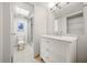 Light and bright bathroom with a white vanity, tiled floor, and walk-in shower at 1028 Apollo Beach Blvd # 203, Apollo Beach, FL 33572