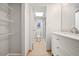 Bright bathroom with a white vanity, tiled floor, and walk-in shower and an adjacent closet at 1028 Apollo Beach Blvd # 203, Apollo Beach, FL 33572