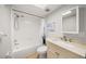 Bright bathroom with vanity, mirror, commode, and tub with shower at 1028 Apollo Beach Blvd # 203, Apollo Beach, FL 33572