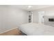 Bright bedroom with neutral walls, ceiling fan, and carpet; open to the kitchen and bathroom at 1028 Apollo Beach Blvd # 203, Apollo Beach, FL 33572