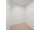 Walk-in closet with carpet and shelving units for storage at 1028 Apollo Beach Blvd # 203, Apollo Beach, FL 33572