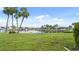 A waterfront view with palm trees and a bench on a sunny day at 1028 Apollo Beach Blvd # 203, Apollo Beach, FL 33572
