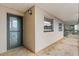 A ground-level exterior view of a condo entrance with windows and a covered walkway at 1028 Apollo Beach Blvd # 203, Apollo Beach, FL 33572