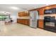 Well-lit kitchen with stainless refrigerator and cherry wood cabinets at 1028 Apollo Beach Blvd # 203, Apollo Beach, FL 33572
