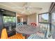 Cozy screened patio features a ceiling fan and vibrant seating near the sliding glass doors at 1028 Apollo Beach Blvd # 203, Apollo Beach, FL 33572