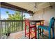 Screened patio with colorful bar chairs, a table, and views of the surrounding landscape at 1028 Apollo Beach Blvd # 203, Apollo Beach, FL 33572