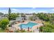 Gorgeous in-ground pool with tables and lounge chairs at 1028 Apollo Beach Blvd # 203, Apollo Beach, FL 33572