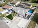Aerial view of property with blue and beige shade covers and a nicely manicured lawn at 1102 Goshen Rd, Tarpon Springs, FL 34689