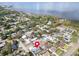 Aerial view of home in a neighborhood near the water, featuring a screened pool and lush greenery at 1102 Goshen Rd, Tarpon Springs, FL 34689