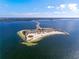 Aerial view of a coastal community with beach and road access surrounded by ocean waters at 1102 Goshen Rd, Tarpon Springs, FL 34689