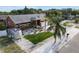Aerial view of the property showcasing a charming single-story home with manicured lawn and landscaping at 1102 Goshen Rd, Tarpon Springs, FL 34689