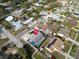 Aerial view of a home with screened in pool, and patio in a residential neighborhood setting at 1102 Goshen Rd, Tarpon Springs, FL 34689