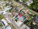 Aerial view of home in a suburban neighborhood with a pool, landscaping, and solar panels at 1102 Goshen Rd, Tarpon Springs, FL 34689