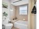 Tiled bathroom includes a tub and shower with a decorative vanity at 1102 Goshen Rd, Tarpon Springs, FL 34689