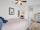 Bright bedroom features wood-look floors, a ceiling fan, and neutral decor at 1102 Goshen Rd, Tarpon Springs, FL 34689