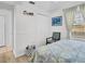 Bright bedroom features wood floors, closet, chair, and natural light at 1102 Goshen Rd, Tarpon Springs, FL 34689