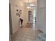 Inviting entryway featuring tile flooring, an elegant light fixture, and decorative wall art at 1102 Goshen Rd, Tarpon Springs, FL 34689